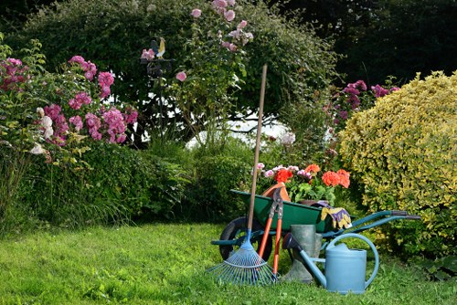 Back garden landscaping in Gunnersbury with seating and greenery