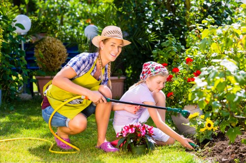 Tidying a communal garden area during garden clearance in Gunnersbury